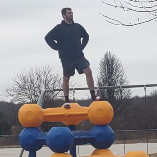 Me striking a really cool pose on a piece of playground equipment.