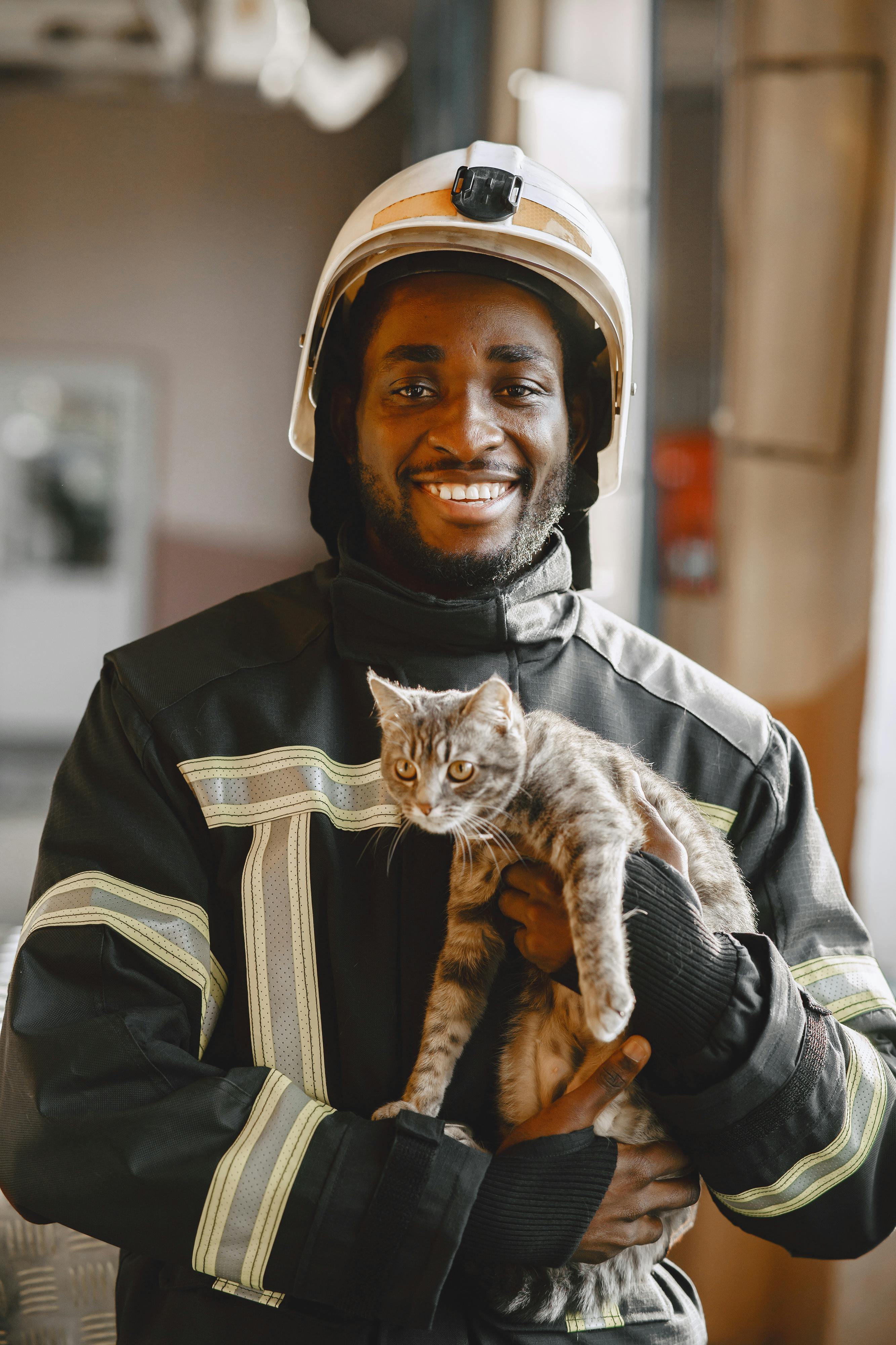 firefighter holding a cat